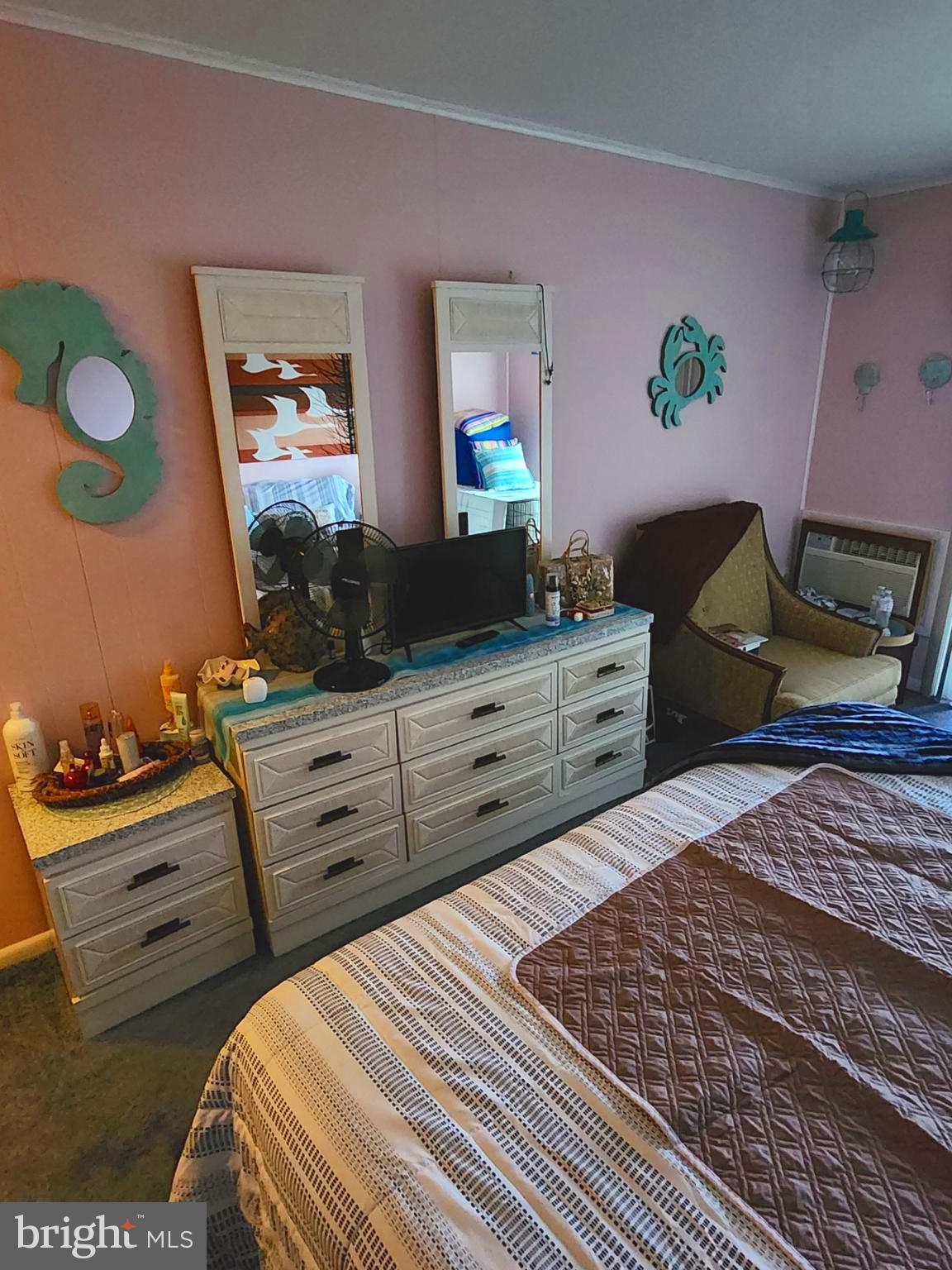 615 Salt Spray Road, Unit 3A Ocean City, MD 21842 - Photo 16 of 23 a bedroom with a bed and a dresser in it