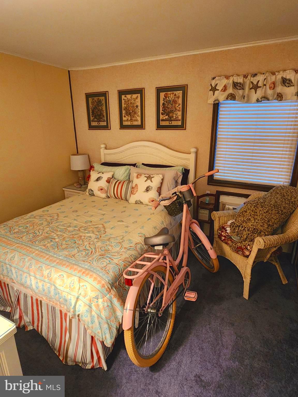 615 Salt Spray Road, Unit 3A Ocean City, MD 21842 - Photo 19 of 23 a bedroom with a bed and glass windows