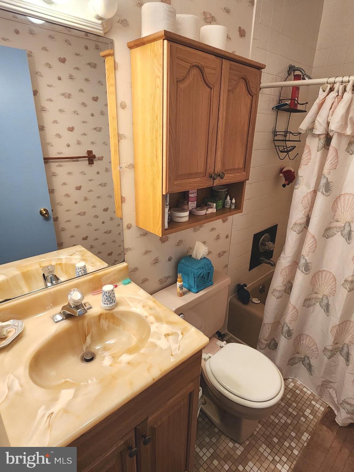 615 Salt Spray Road, Unit 3A Ocean City, MD 21842 - Photo 20 of 23 a bathroom with a sink toilet and shower