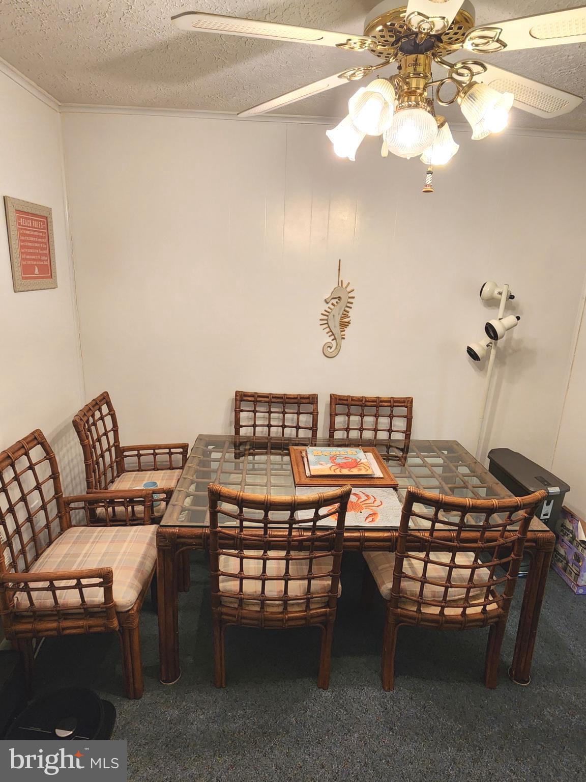 615 Salt Spray Road, Unit 3A Ocean City, MD 21842 - Photo 8 of 23 a view of a dining room with furniture and chandelier