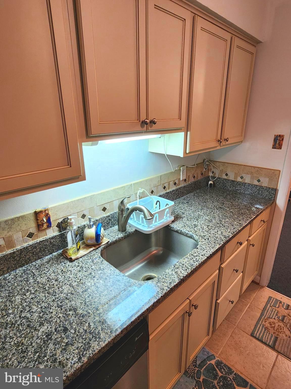 615 Salt Spray Road, Unit 3A Ocean City, MD 21842 - Photo 10 of 23 a kitchen with granite countertop a sink and a white cabinets