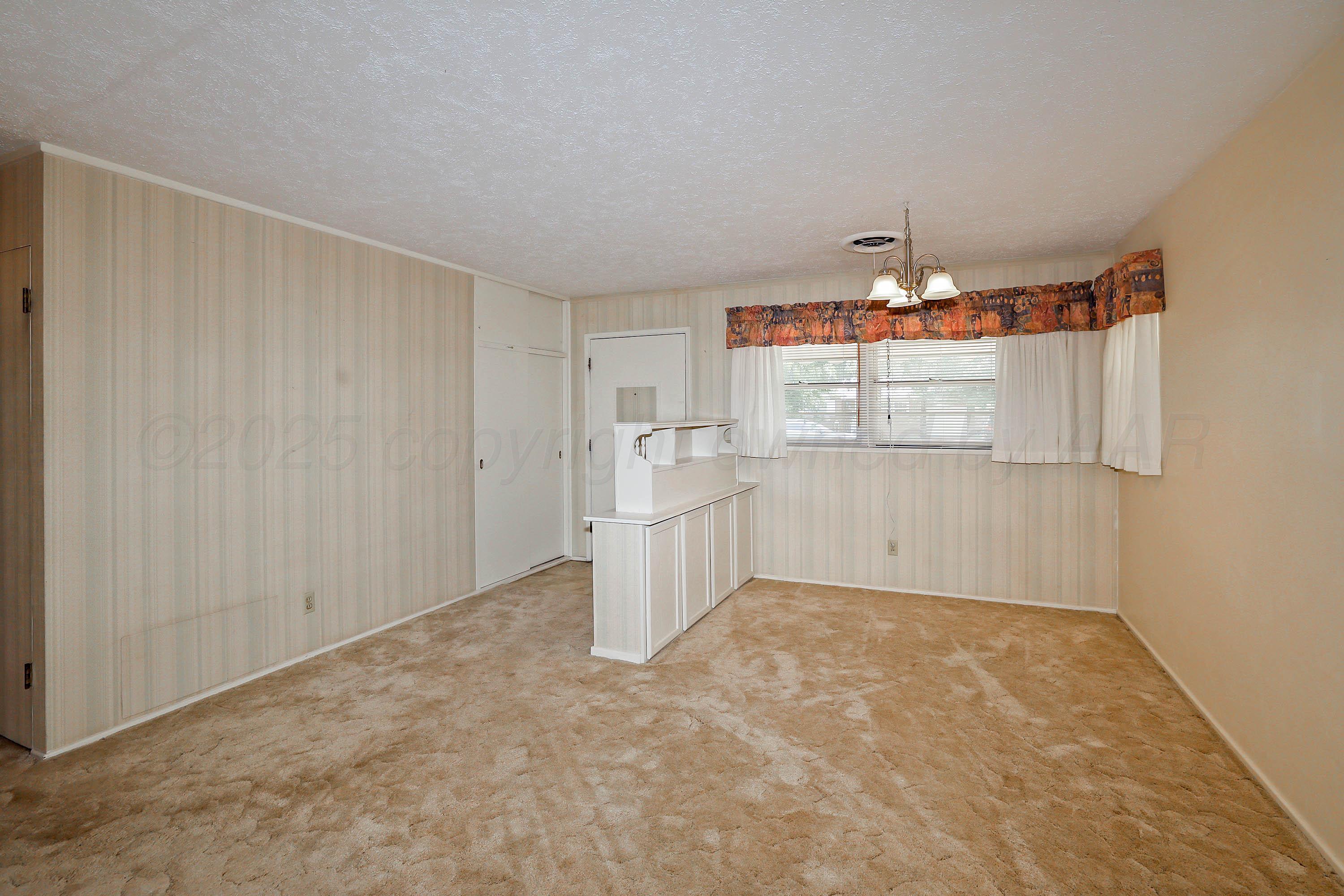 5119 South Bonham Street Amarillo, TX 79110 - Photo 11 of 32 a view of a kitchen with a dishwasher and cabinets