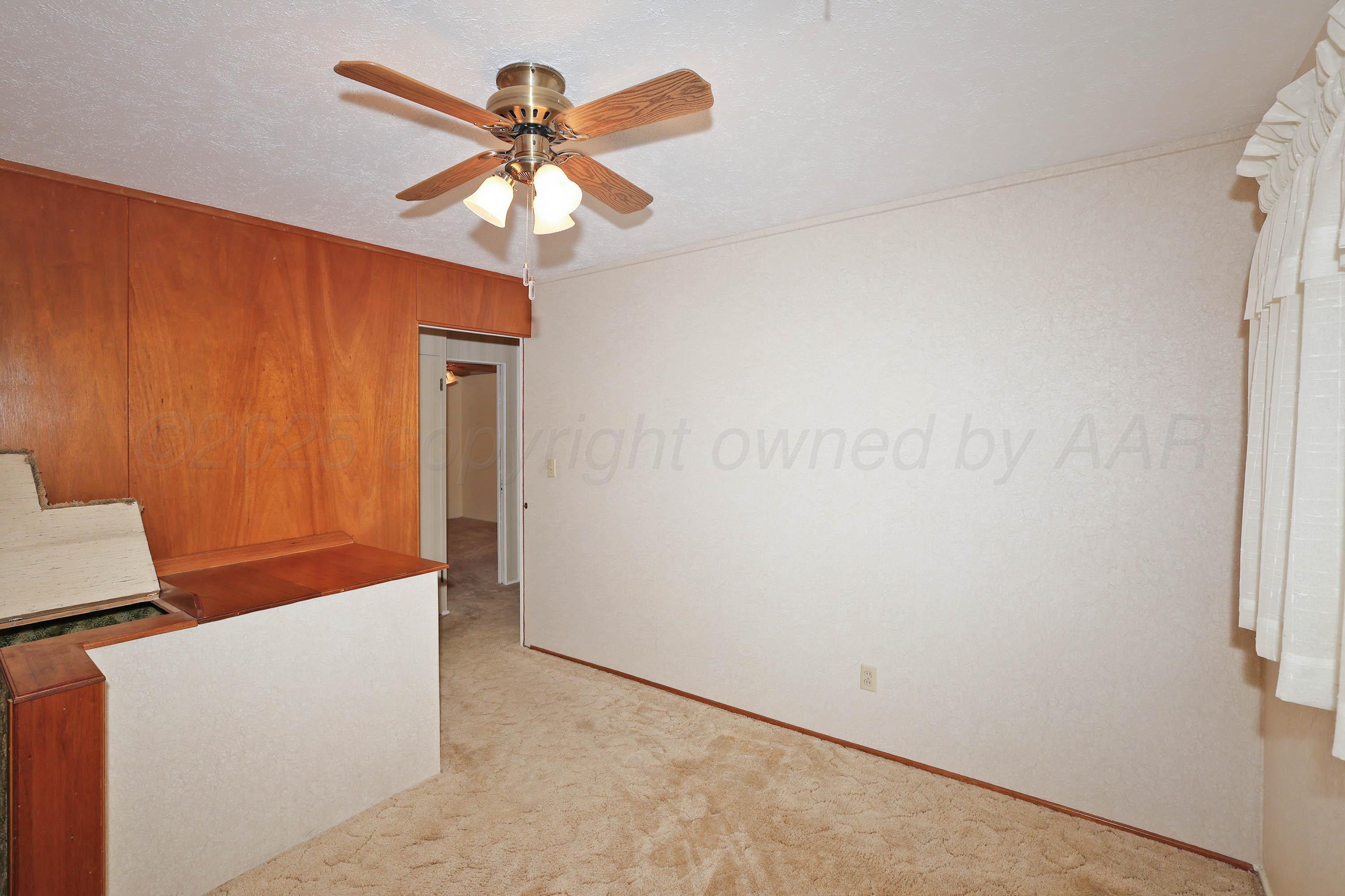 5119 South Bonham Street Amarillo, TX 79110 - Photo 20 of 32 an empty room with a ceiling fan and a window