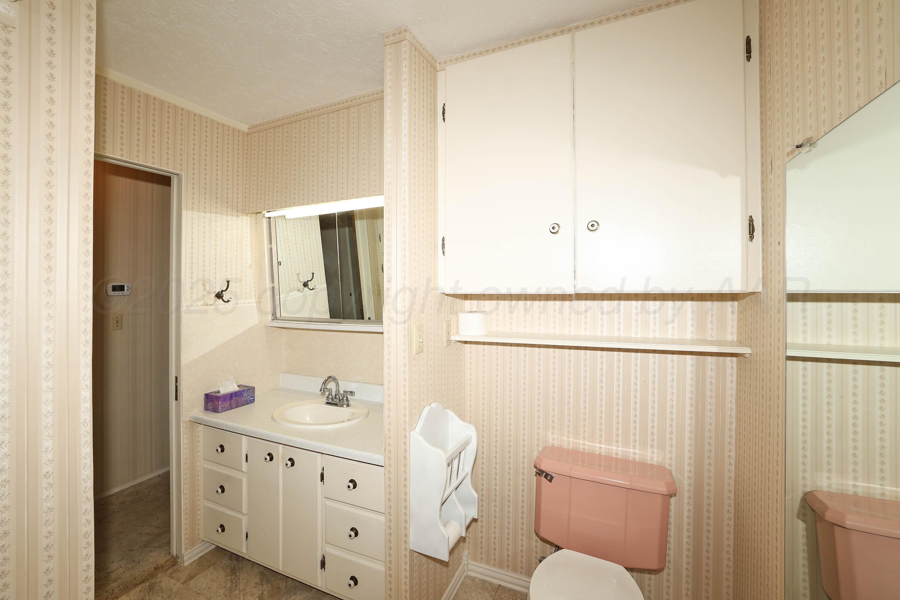 5119 South Bonham Street Amarillo, TX 79110 - Photo 22 of 32 a bathroom with a double vanity sink mirror and toilet