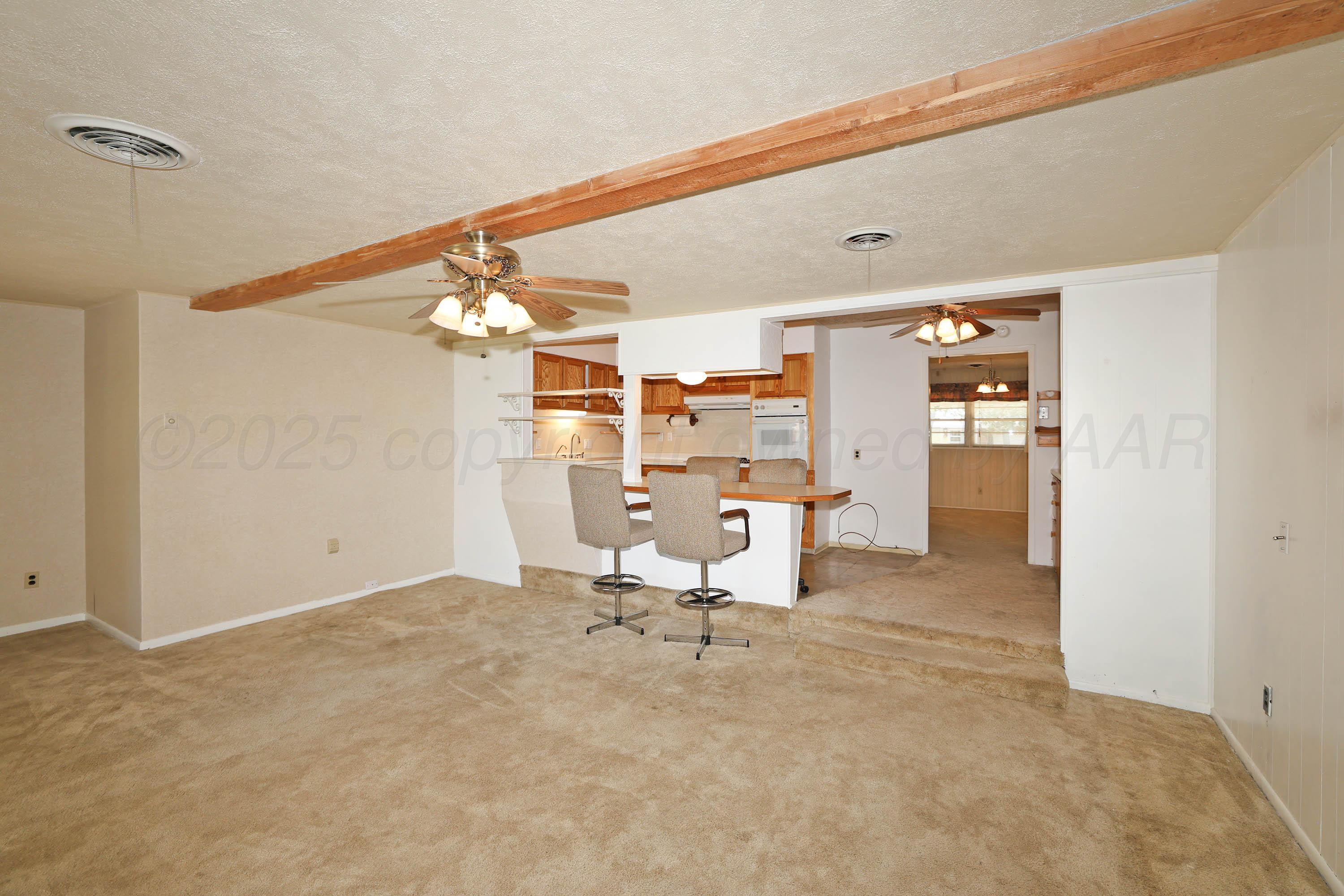 5119 South Bonham Street Amarillo, TX 79110 - Photo 5 of 32 a living room with furniture and a chandelier