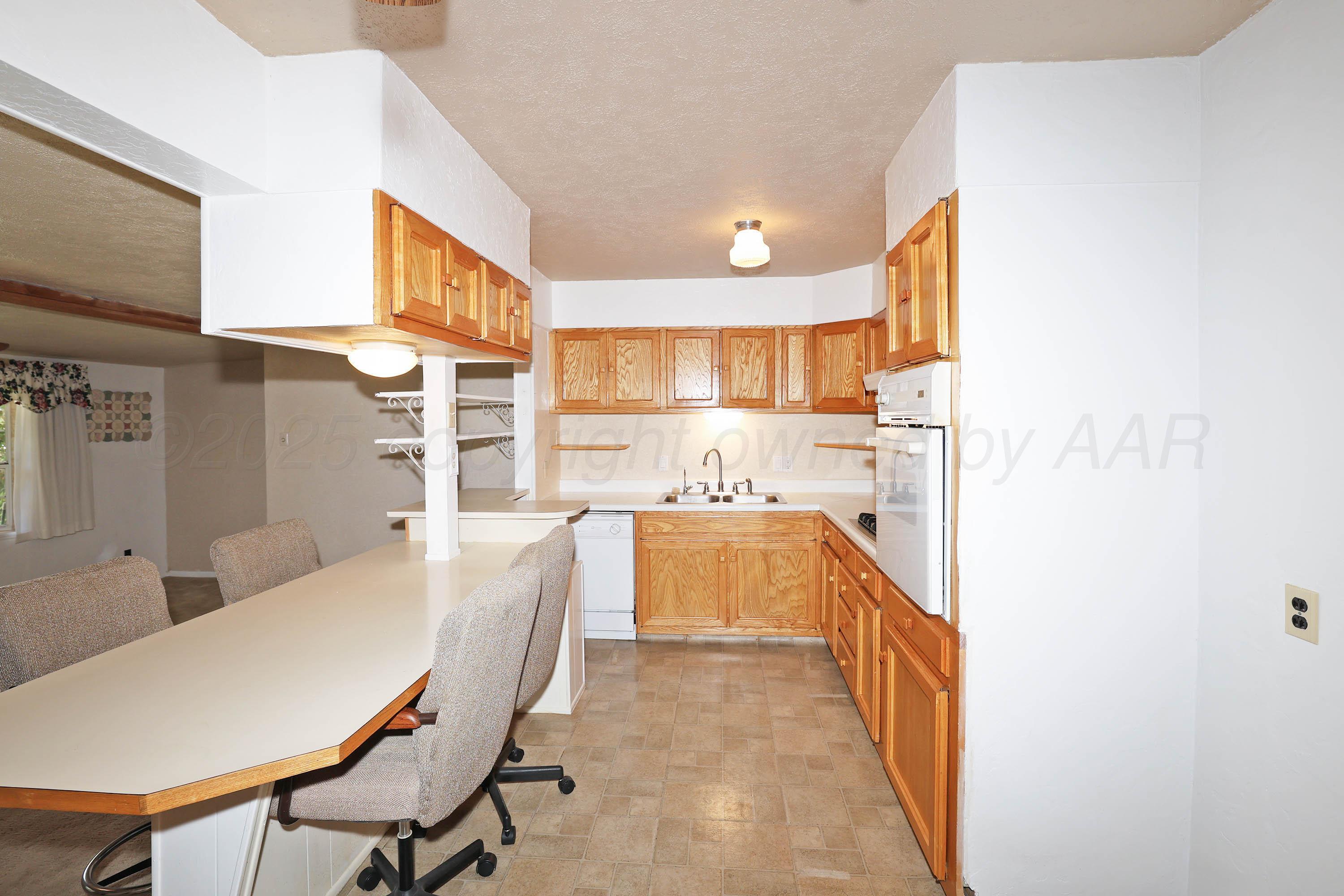 5119 South Bonham Street Amarillo, TX 79110 - Photo 6 of 32 a large white kitchen with a large window