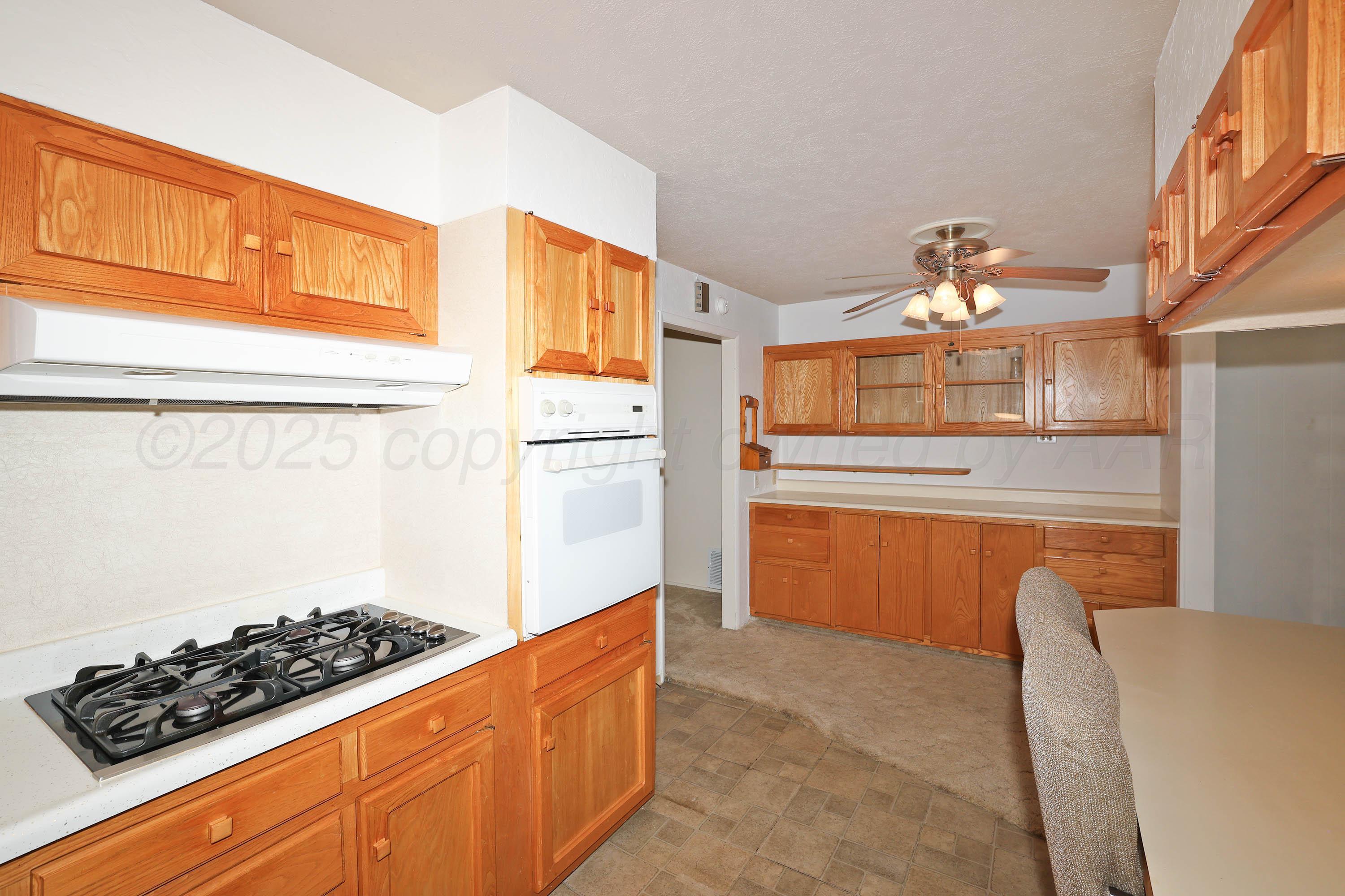 5119 South Bonham Street Amarillo, TX 79110 - Photo 7 of 32 a kitchen with stainless steel appliances granite countertop a stove a sink and a refrigerator
