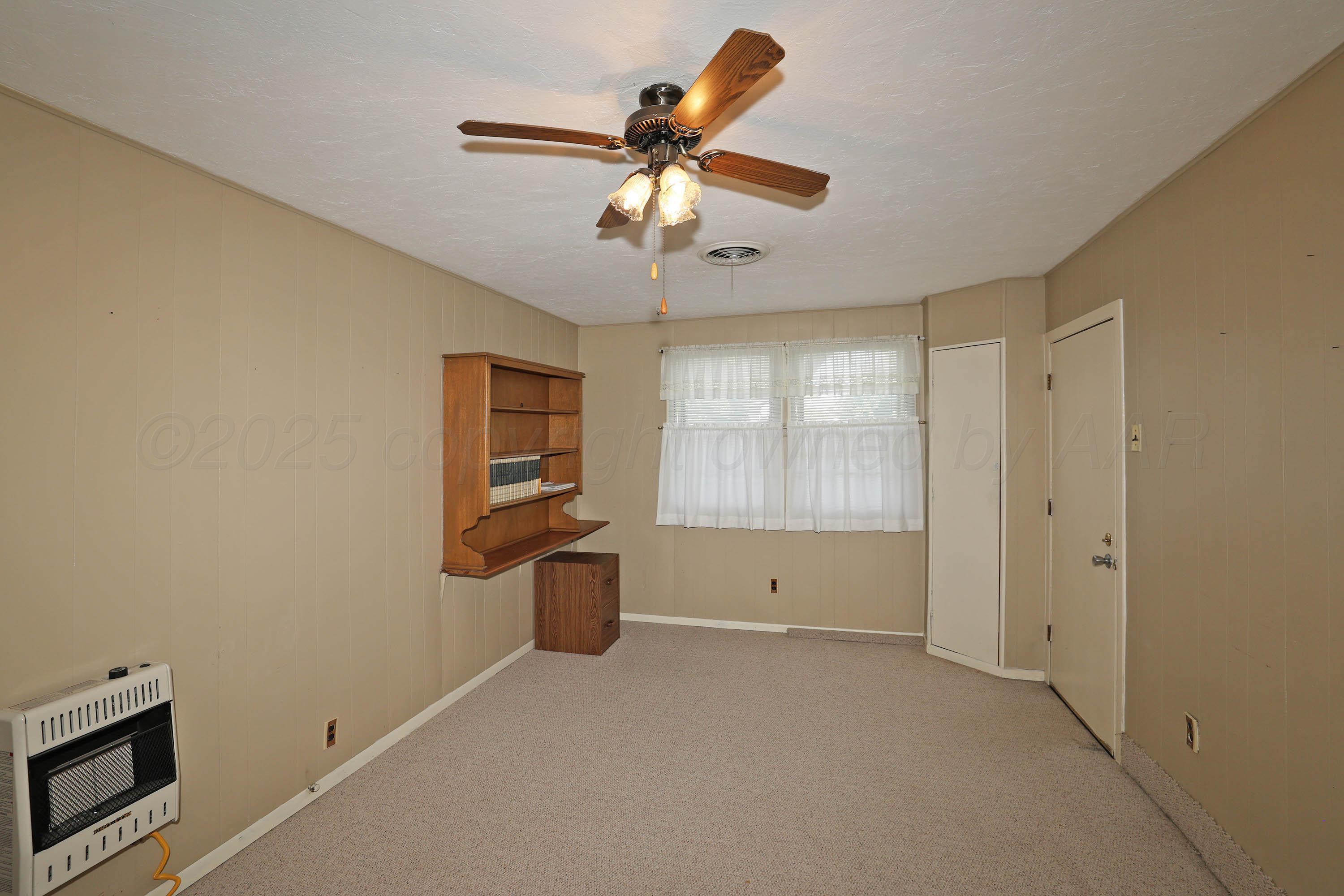 5119 South Bonham Street Amarillo, TX 79110 - Photo 8 of 32 a view of room with a ceiling fan and window