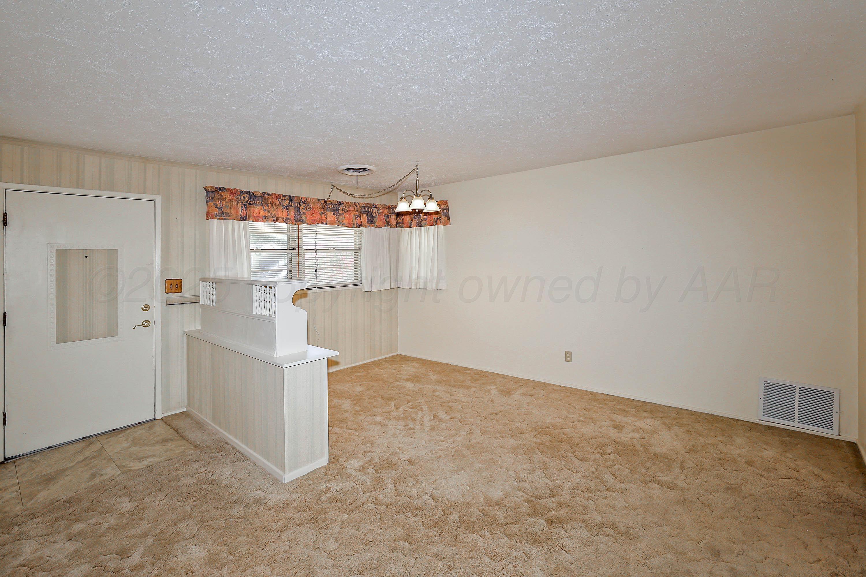 5119 South Bonham Street Amarillo, TX 79110 - Photo 10 of 32 an empty room with entrance and door