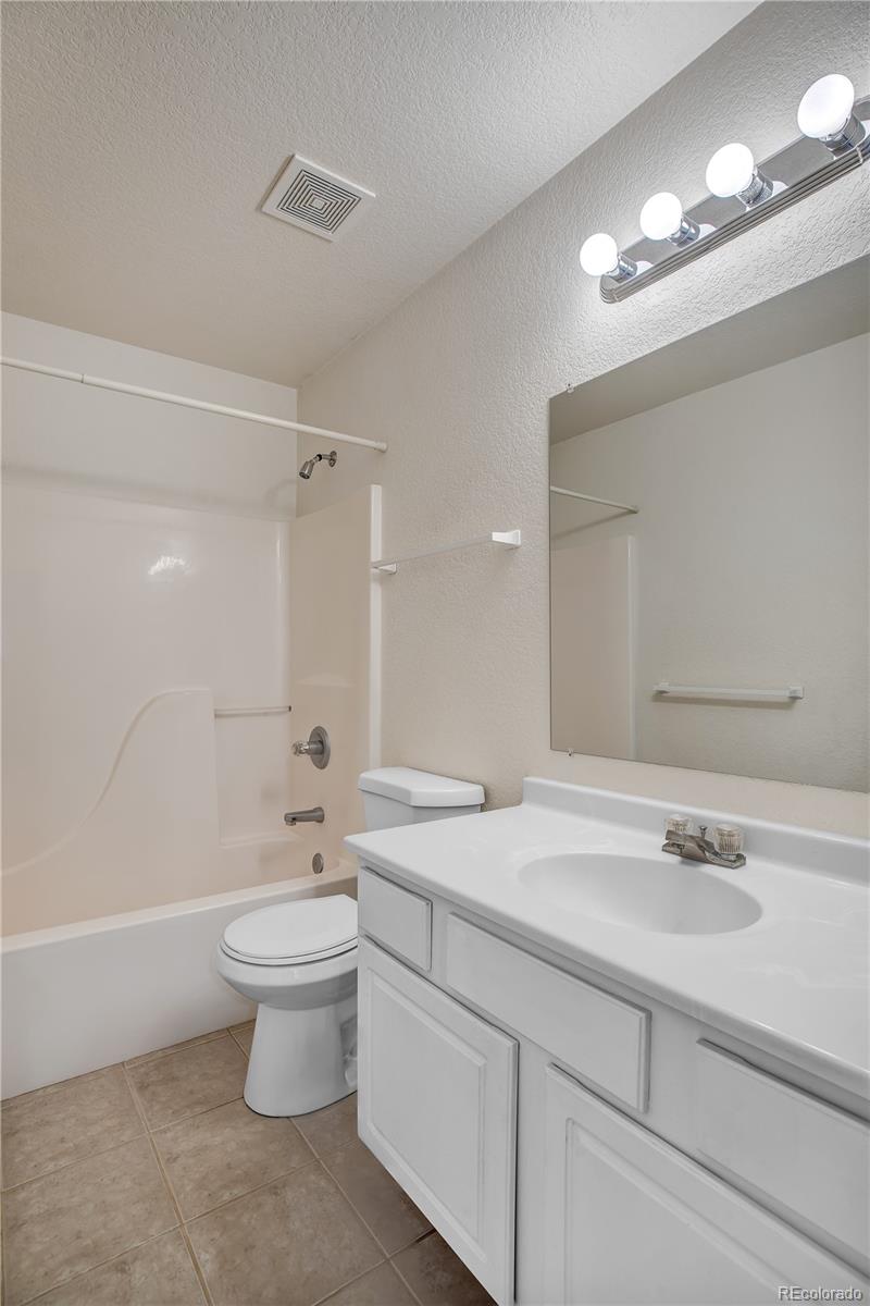 11690 West 46th Avenue Wheat Ridge, CO 80033 - Photo 23 of 33 a bathroom with a sink a toilet and shower