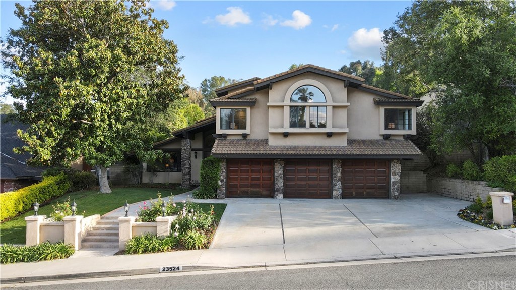 23524 Highland Glen Drive Newhall, CA 91321 - Photo 1 of 53 a front view of a house with a yard and garage