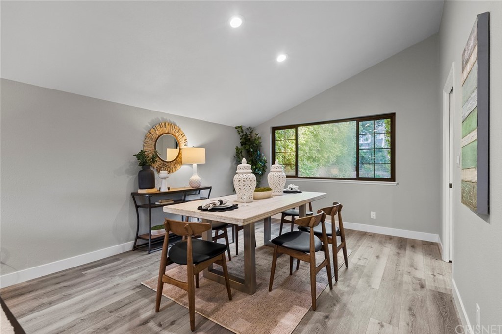 23524 Highland Glen Drive Newhall, CA 91321 - Photo 16 of 53 a view of a dining room with furniture and wooden floor