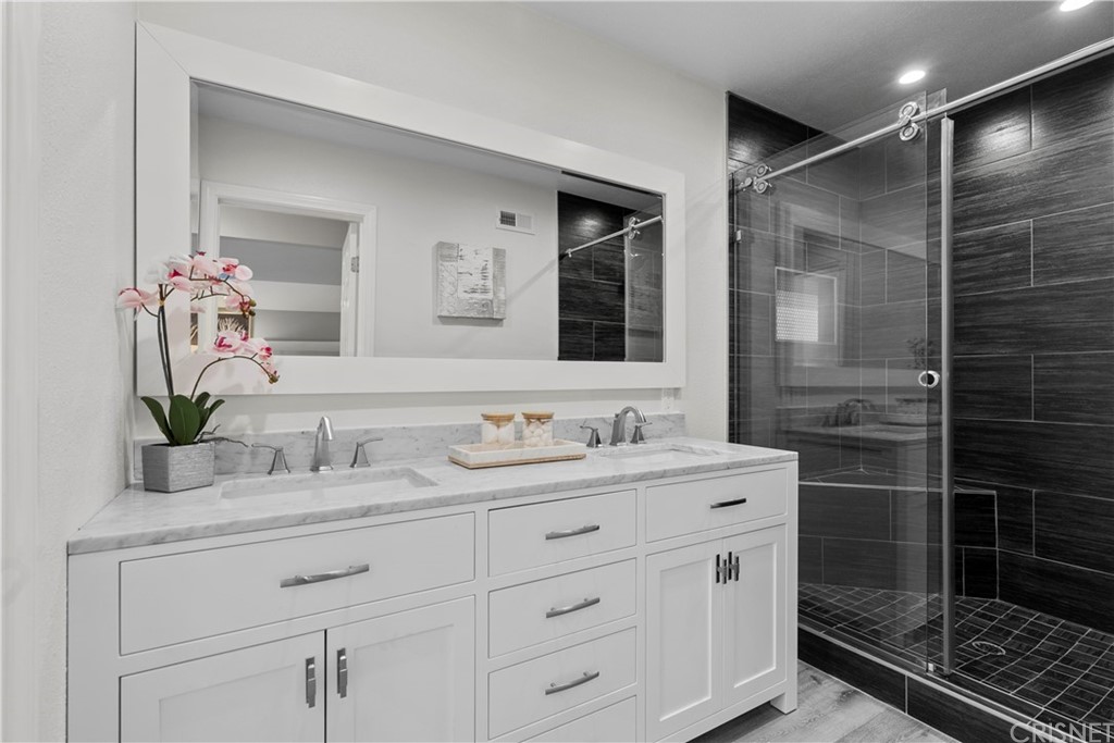 23524 Highland Glen Drive Newhall, CA 91321 - Photo 33 of 53 a bathroom with a shower sink and mirror