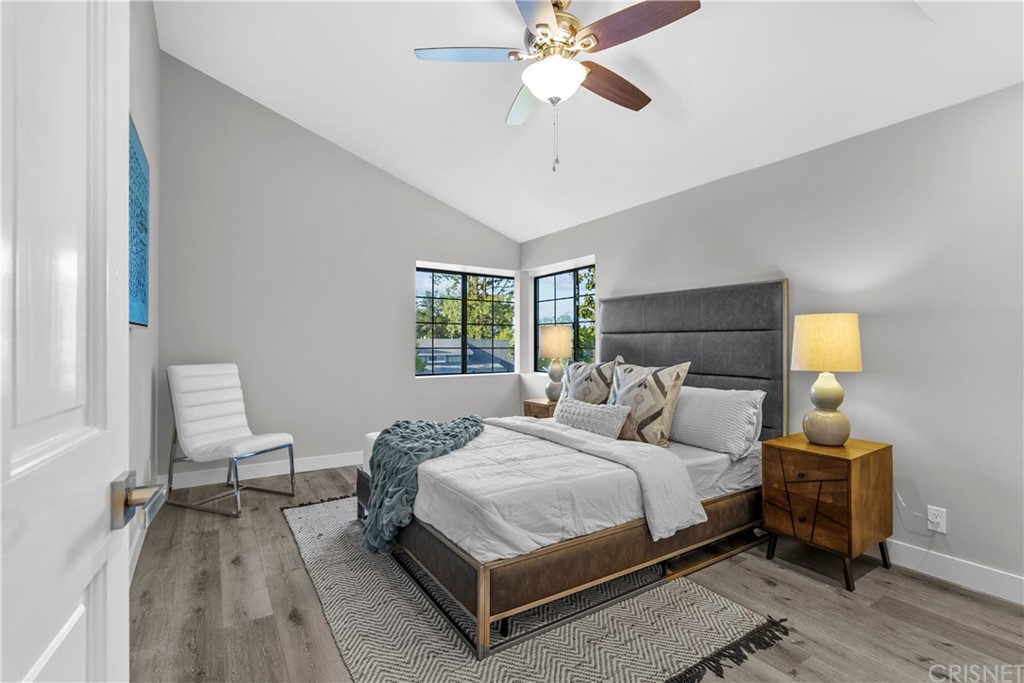 23524 Highland Glen Drive Newhall, CA 91321 - Photo 35 of 53 a bedroom with a bed lamp chandelier and a window