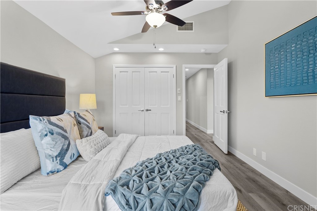 23524 Highland Glen Drive Newhall, CA 91321 - Photo 37 of 53 a bedroom with a bed and a chandelier