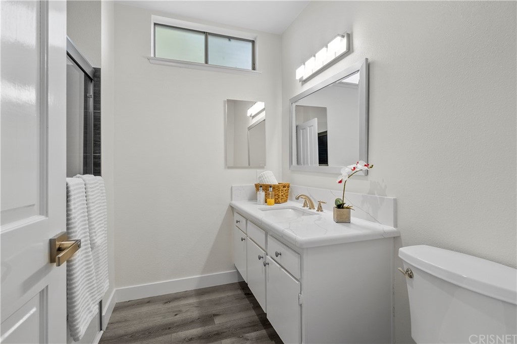 23524 Highland Glen Drive Newhall, CA 91321 - Photo 40 of 53 a bathroom with a double vanity sink mirror and toilet