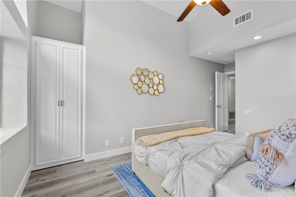 23524 Highland Glen Drive Newhall, CA 91321 - Photo 42 of 53 a bedroom with a bed and a chandelier