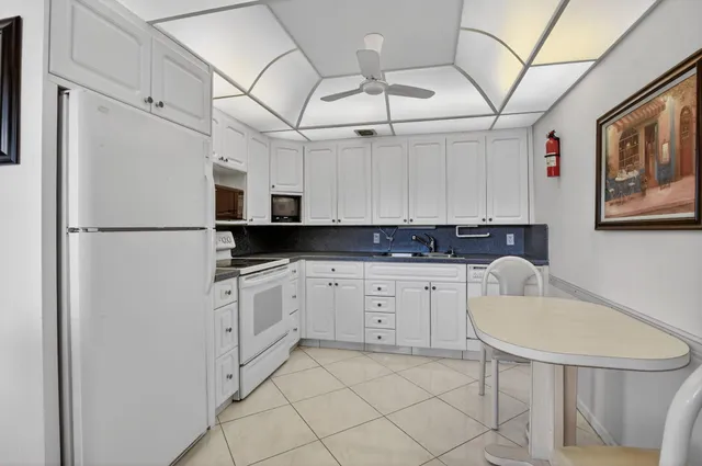 a dining room with furniture and a floor to ceiling window