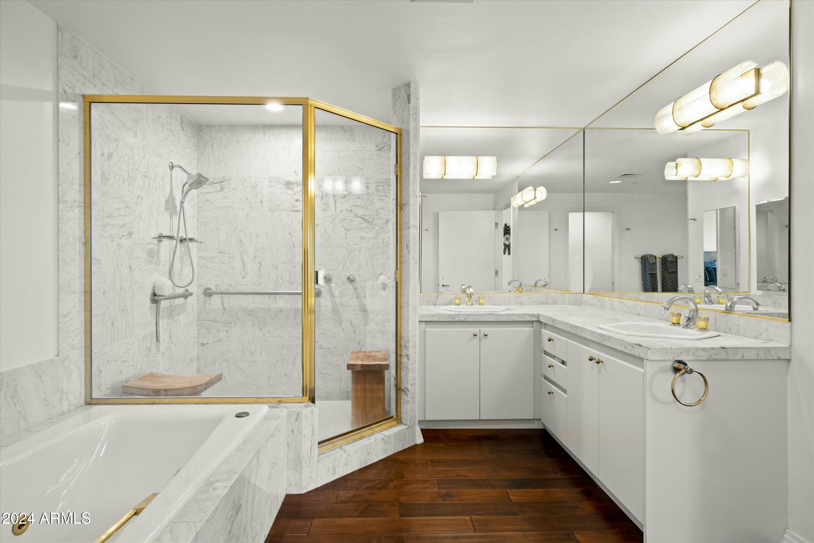 1040 East Osborn Road, Unit 1201 Phoenix, AZ 85014 - Photo 15 of 28 a spacious bathroom with a tub sink shower and mirror
