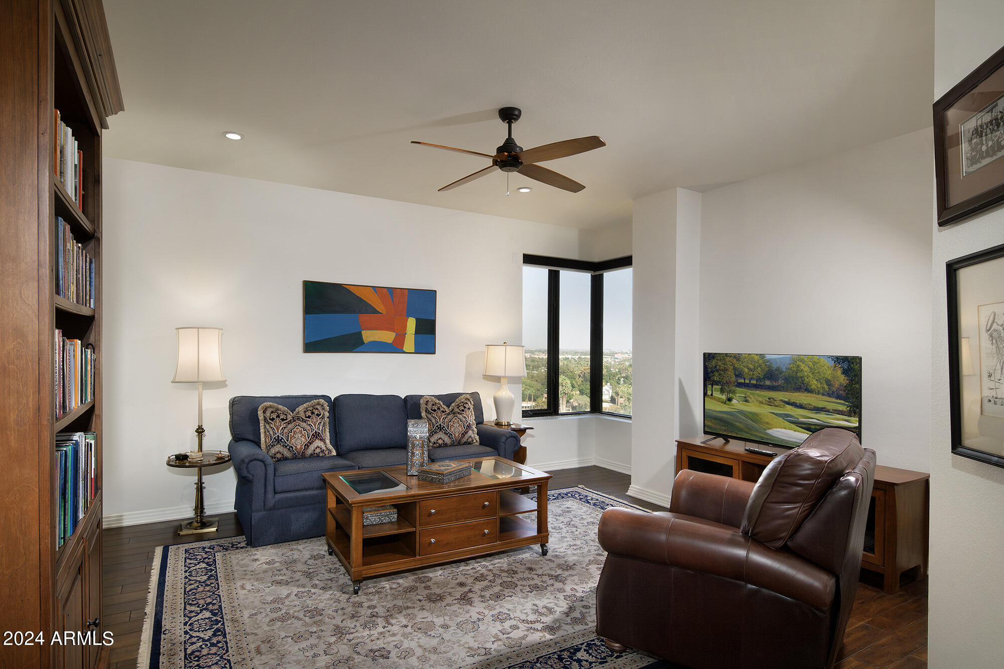 1040 East Osborn Road, Unit 1201 Phoenix, AZ 85014 - Photo 16 of 28 a living room with furniture and a flat screen tv