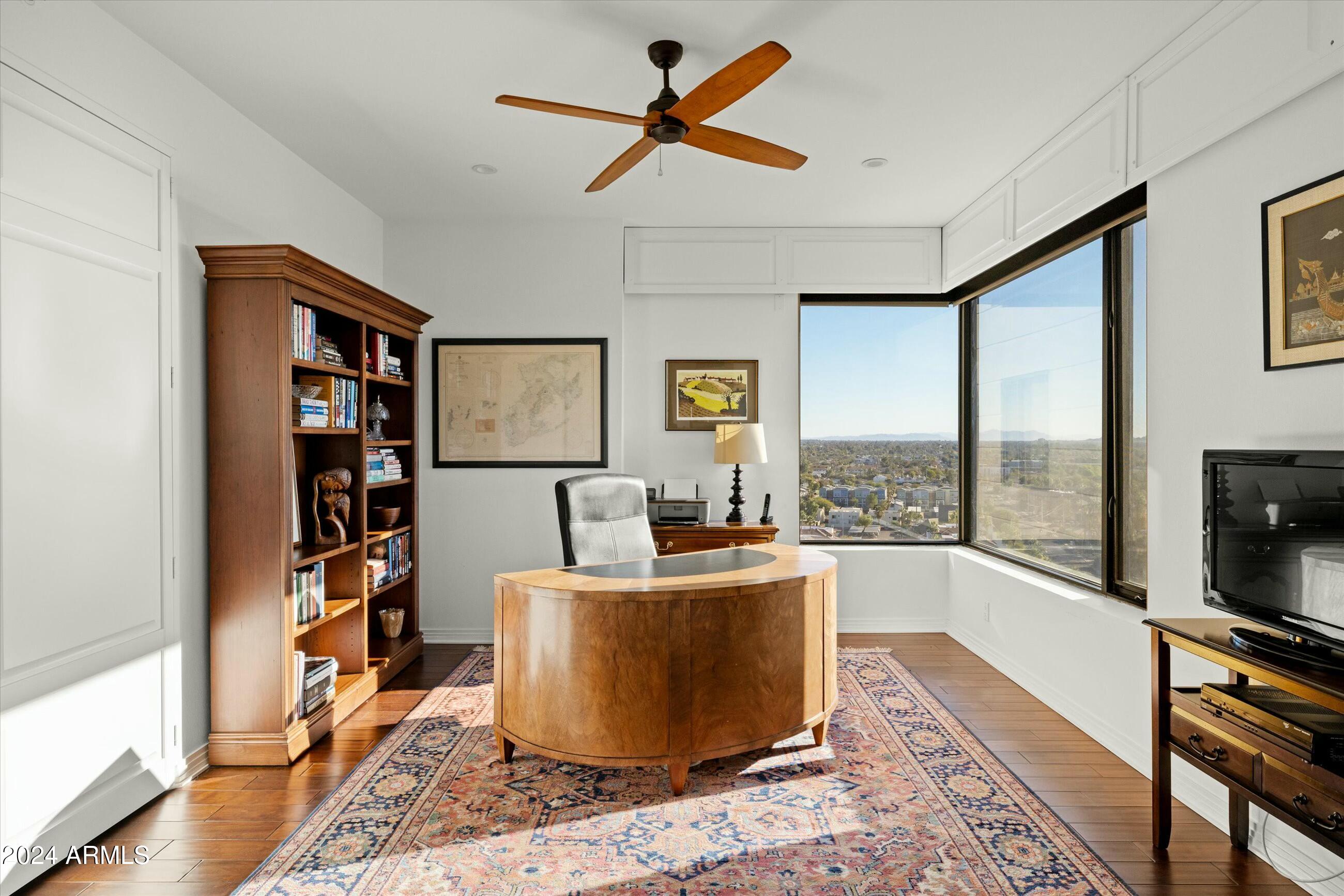 1040 East Osborn Road, Unit 1201 Phoenix, AZ 85014 - Photo 18 of 28 a living room with furniture a rug and a flat screen tv