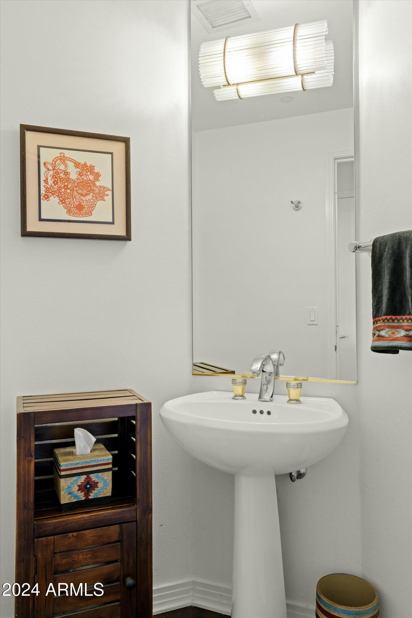 1040 East Osborn Road, Unit 1201 Phoenix, AZ 85014 - Photo 19 of 28 a bathroom with a sink a mirror and a toilet