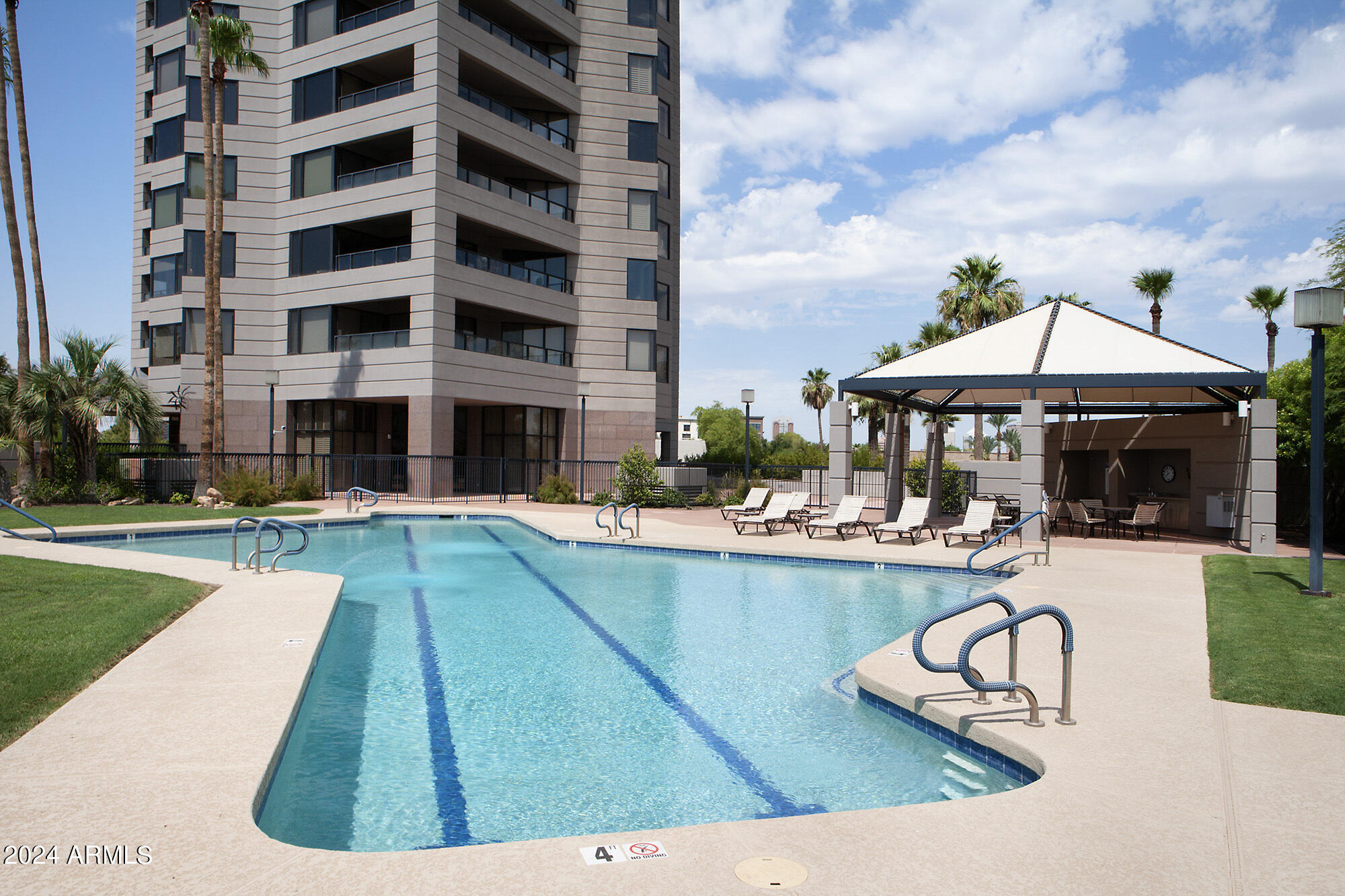 1040 East Osborn Road, Unit 1201 Phoenix, AZ 85014 - Photo 20 of 28 a swimming pool with outdoor seating