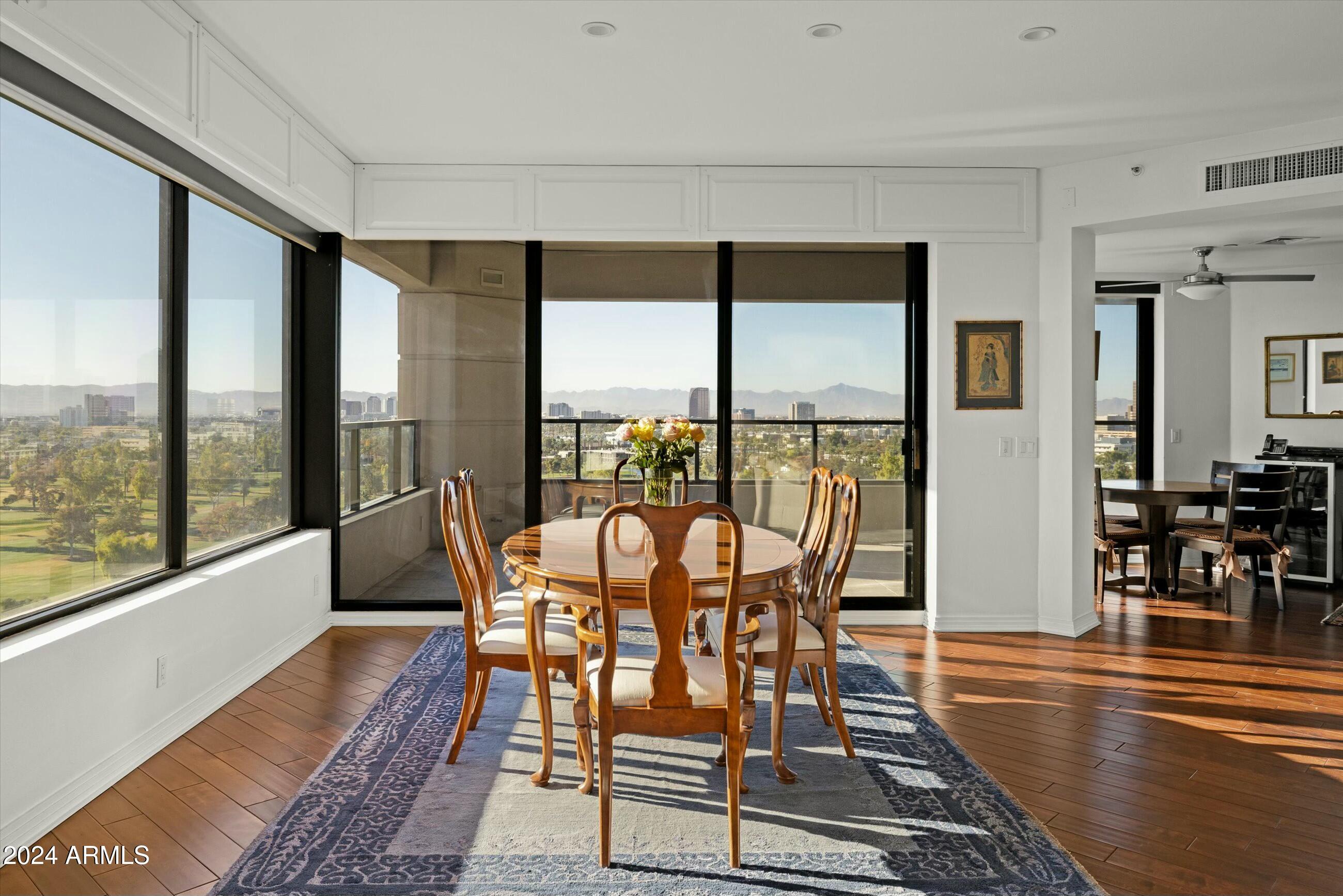 1040 East Osborn Road, Unit 1201 Phoenix, AZ 85014 - Photo 6 of 28 a view of a dining room with furniture window and wooden floor