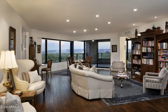 a living room with furniture and a book shelf
