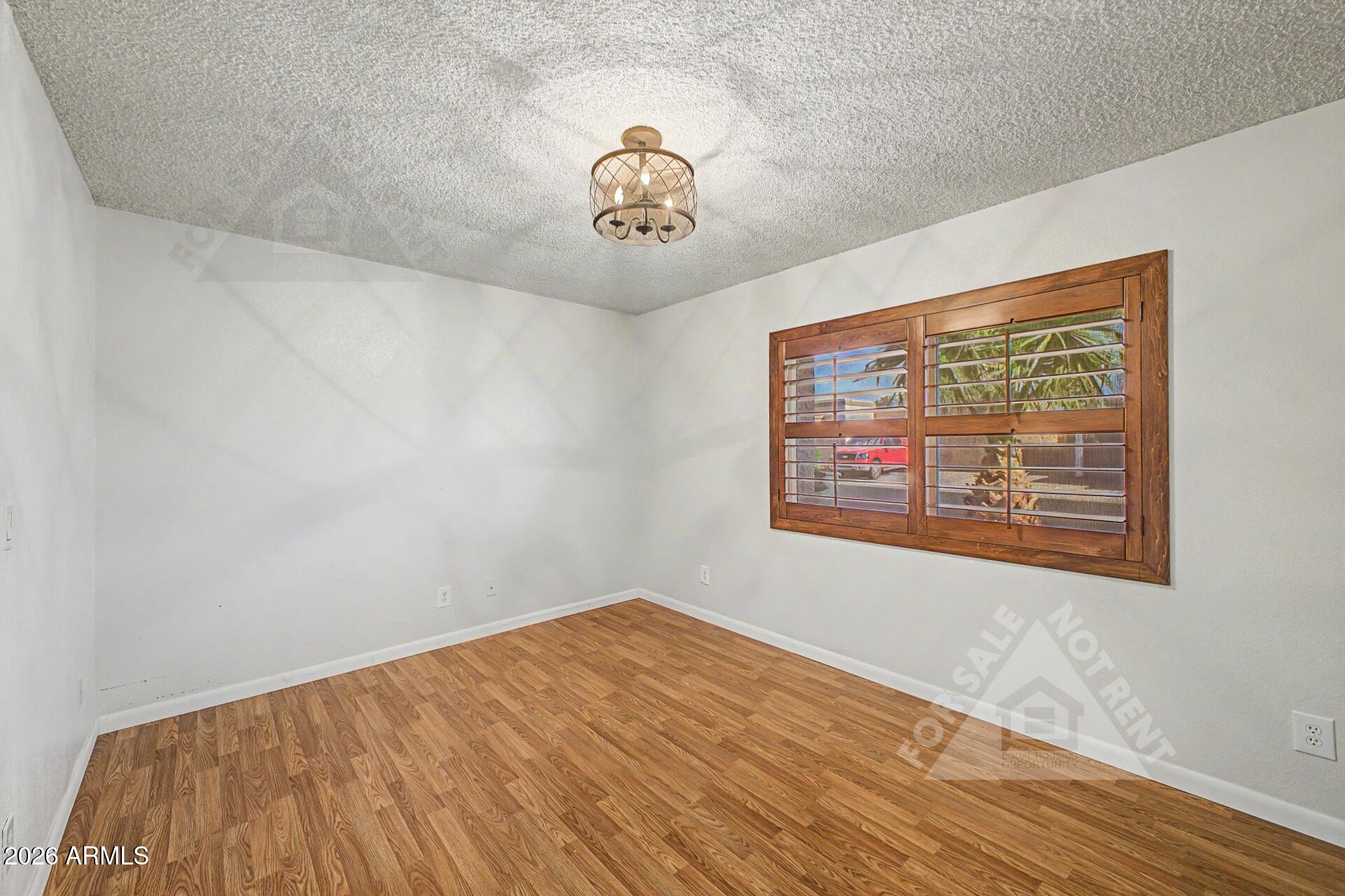 912 East Villa Rita Drive Phoenix, AZ 85022 - Photo 14 of 27 a view of a room with wooden floor and window