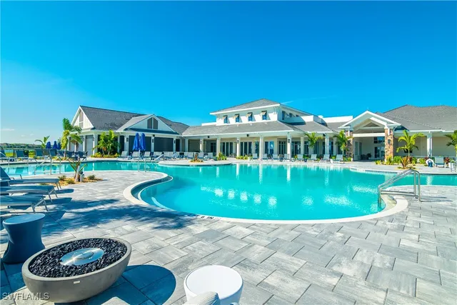 a view of a house with swimming pool and a yard