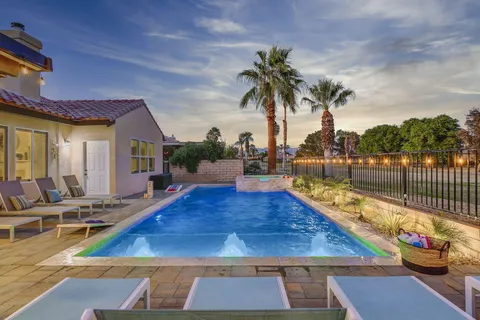 a view of a swimming pool with lounge chair