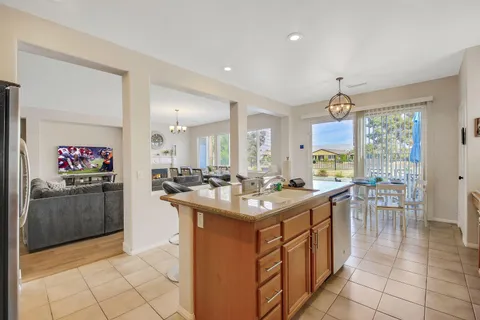 a kitchen with stainless steel appliances granite countertop a sink and a refrigerator