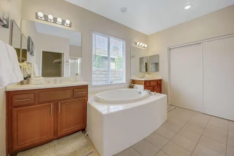 a bathroom with a sink a mirror and a bathtub