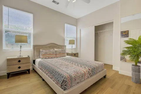 a bedroom with a bed and a potted plant