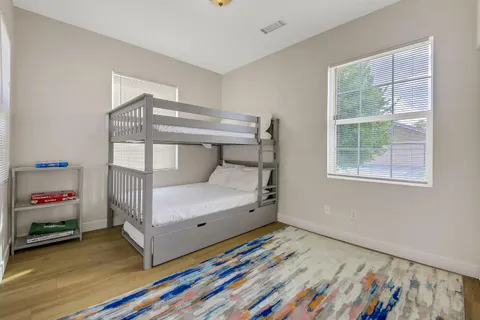 a bedroom with a bunk bed and a window