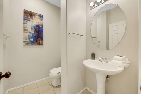 a bathroom with a sink mirror and toilet