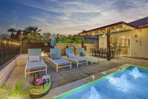 a view of a patio with table and chairs and potted plants