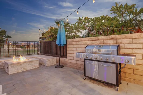a view of a patio with dining table and chairs