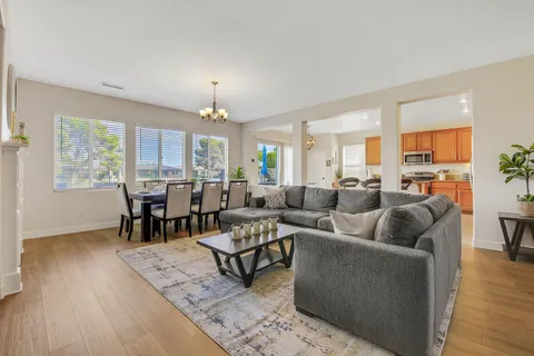 a living room with furniture dining table and a fireplace