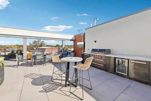 a dining room with furniture and a floor to ceiling window