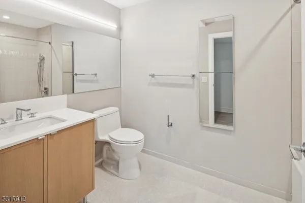 a white toilet sitting next to a bathroom sink