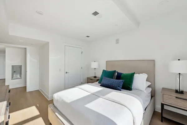 a bedroom with a bed and a lamp