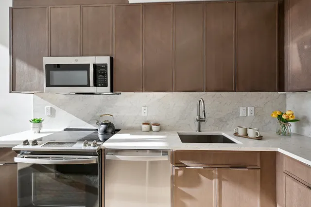 a kitchen with a sink cabinets and stainless steel appliances
