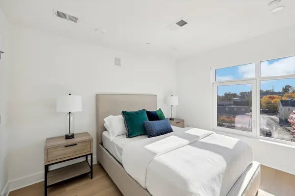 a bedroom with a bed and window