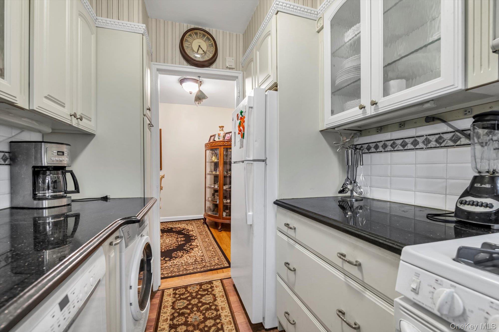 69-18 Bell Boulevard, Unit B Queens, NY 11364 - Photo 5 of 9 a kitchen with a stove and a refrigerator
