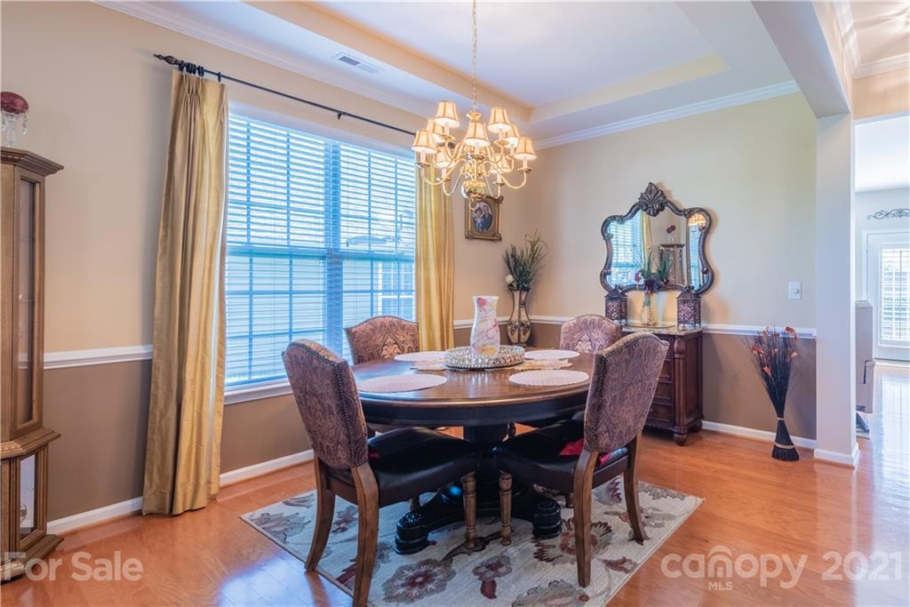 279 Garnet Court, Unit 549 Fort Mill, SC 29708 - Photo 11 of 47 a view of a dining room with furniture and chandelier
