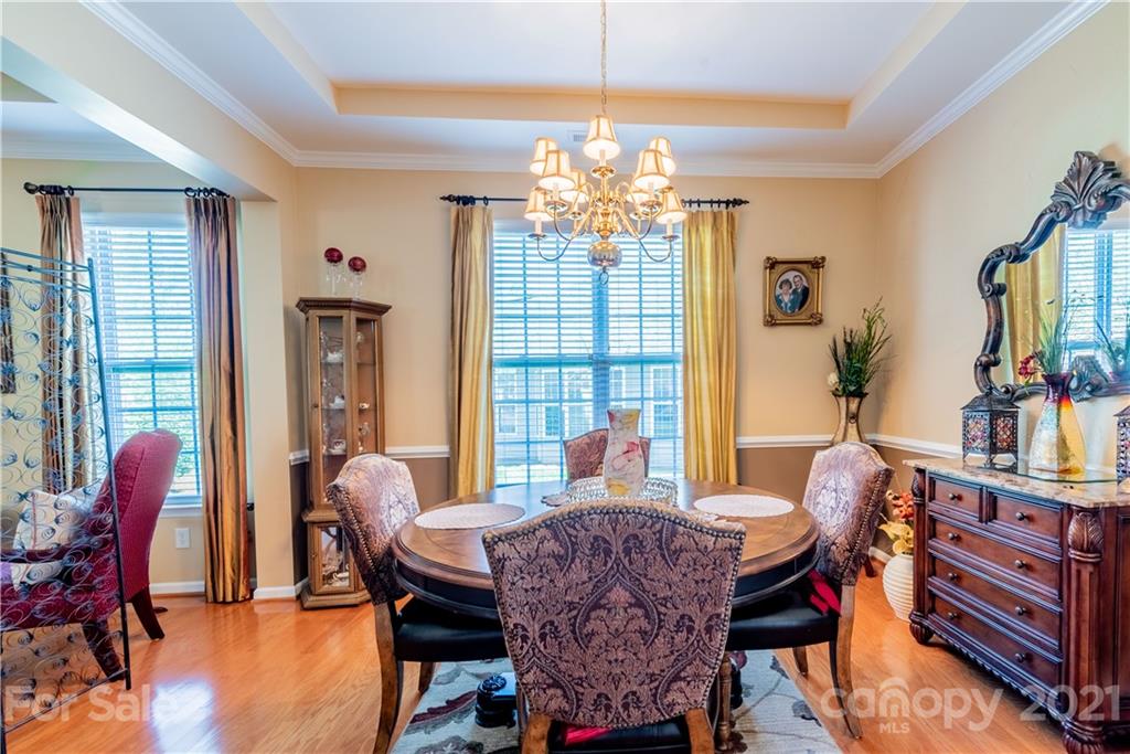 279 Garnet Court, Unit 549 Fort Mill, SC 29708 - Photo 12 of 47 a view of a dining room with furniture and a chandelier