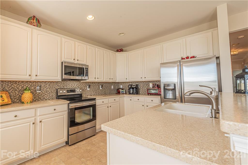 279 Garnet Court, Unit 549 Fort Mill, SC 29708 - Photo 15 of 47 a kitchen with sink a microwave and cabinets