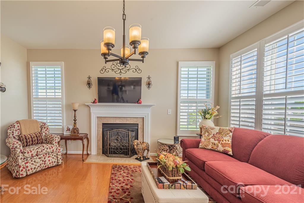 279 Garnet Court, Unit 549 Fort Mill, SC 29708 - Photo 18 of 47 a living room with furniture a fireplace and a large window